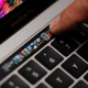 An Apple employee points to the Touch Bar on a new Apple MacBook Pro laptop during a product launch event on October 27, 2016 in Cupertino, California.
